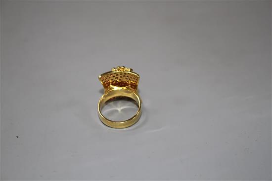 A modern yellow metal (etched? 18k), pave set ruby and diamond dress ring, size N, gross 10 grams.